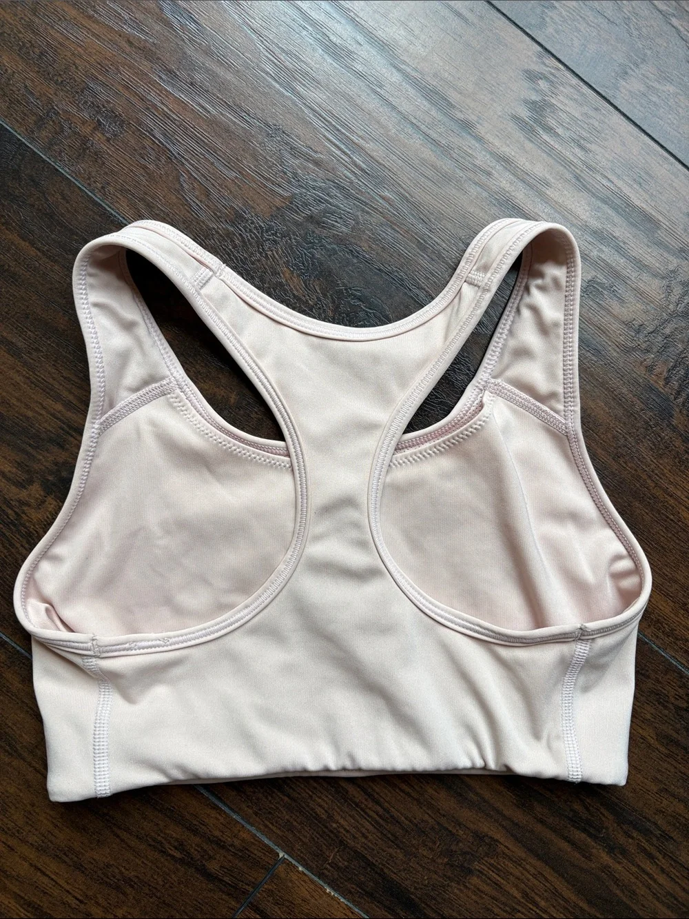 Nike Women’s light beige Racerback Sports Bra with Black Swoosh